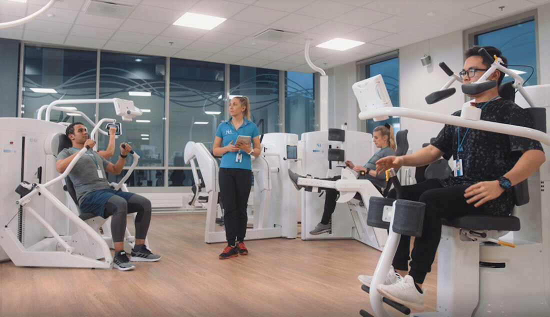 People using specialised medical fitness equipment with professional supervision