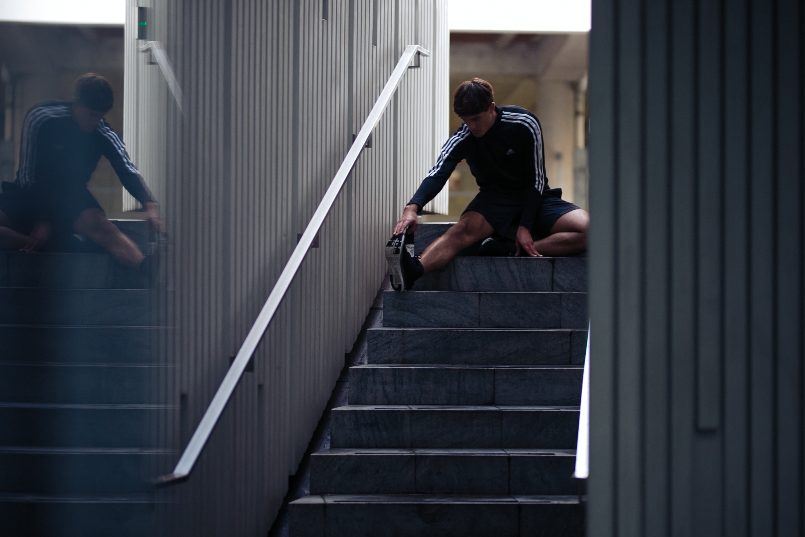 A group of runners posing on a bridge
